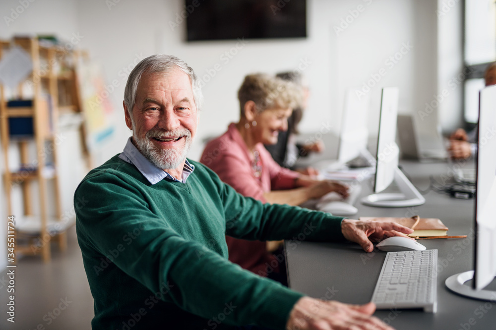 Portrait of senior man attending computer and technology education class. Portrait of senior man attending computer and technology education class.