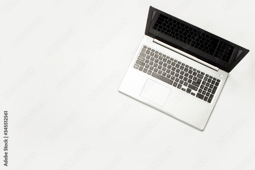 Laptop on a light white background. Technology concept. Flat lay, top view Laptop on a light white background. Technology concept. Flat lay, top view