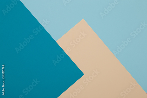 Blue and yellow background, colored paper geometrically divides into zones, frame, copy, space.