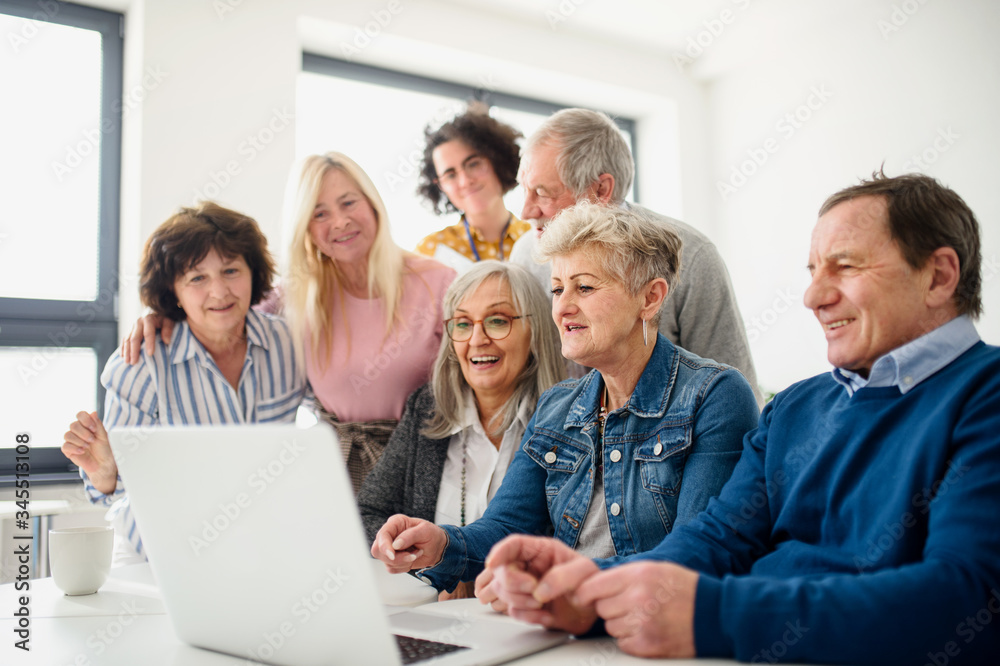 Group of senior people attending computer and technology education class.