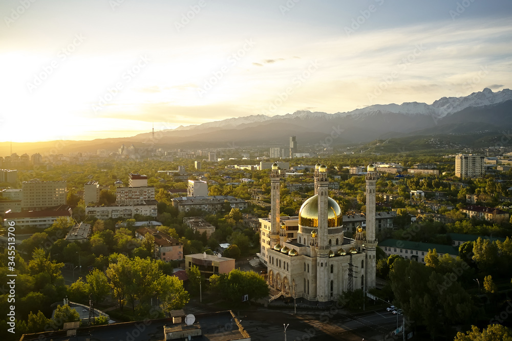 Aerial view of mosque with gold dome at sunrise in Almaty city , Kazakhstan