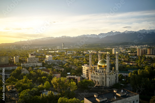 Aerial view of mosque with gold dome at sunrise in Almaty city , Kazakhstan