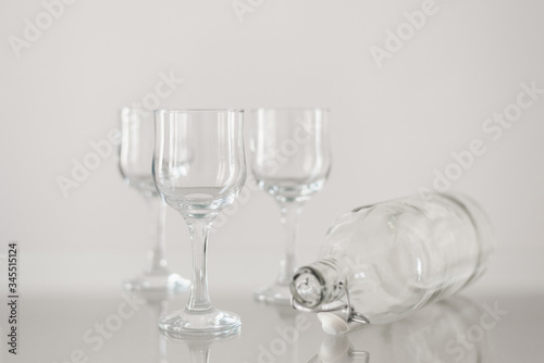 Empty wine glasses and water bottle on glass table. Glassware for catering