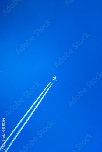 The trace of a flying plane in the blue sky
