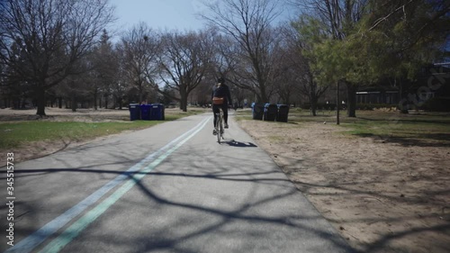 Wallpaper Mural A Man Cycling In The Peaceful Pathway In Canada - Wide Shot Torontodigital.ca