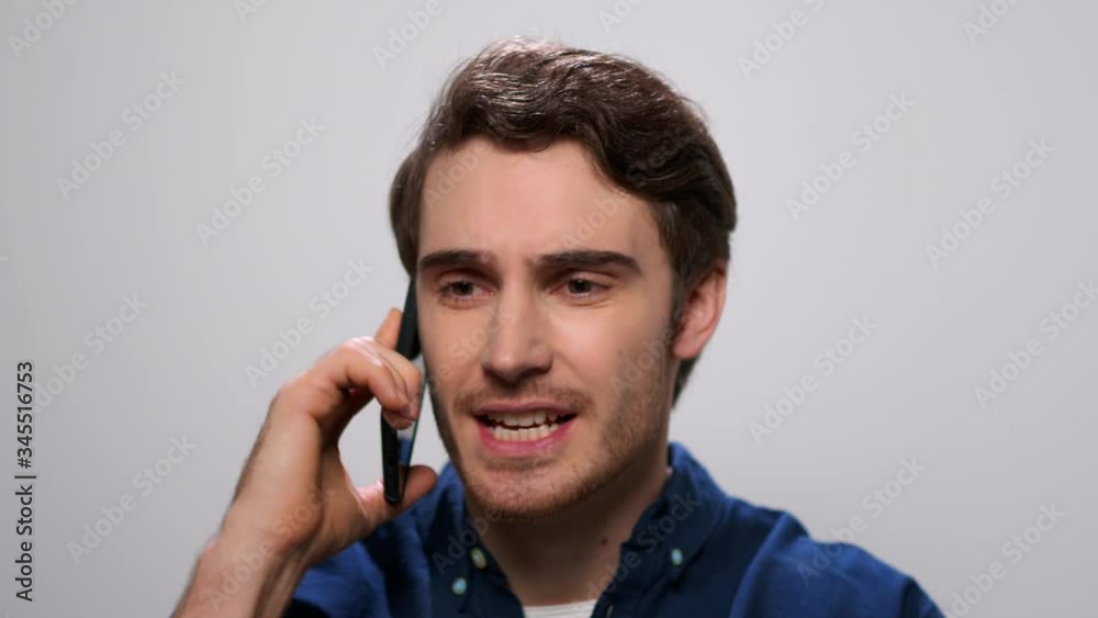 Man talking on phone in studio. Guy screaming during phone conversation Man talking on phone in studio. Guy screaming during phone conversation