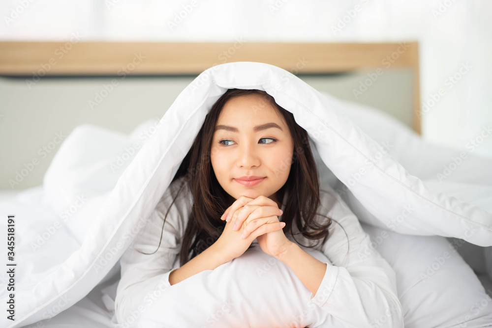 Asian woman hug the pillow in the bed smile and happy Asian woman hug the pillow in the bed smile and happy