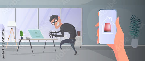 Thief in the house. A robber steals data from a laptop. The concept of safety and security premises. Flat style vector illustration.