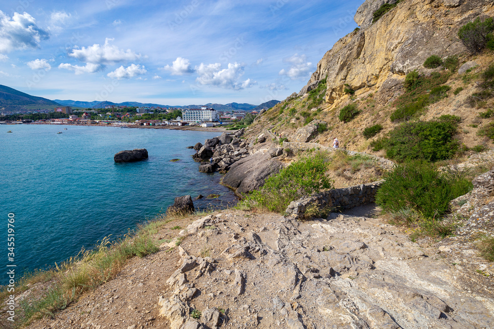 Beautiful summer sea landscape at the resort in the Crimea. View of the city from the mountain trail. Rocky coast of the black sea. Seascape.