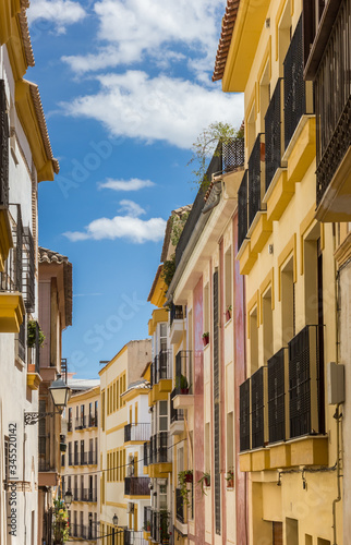 Colorful houses in a narrow street in Lorca, Spain © venemama