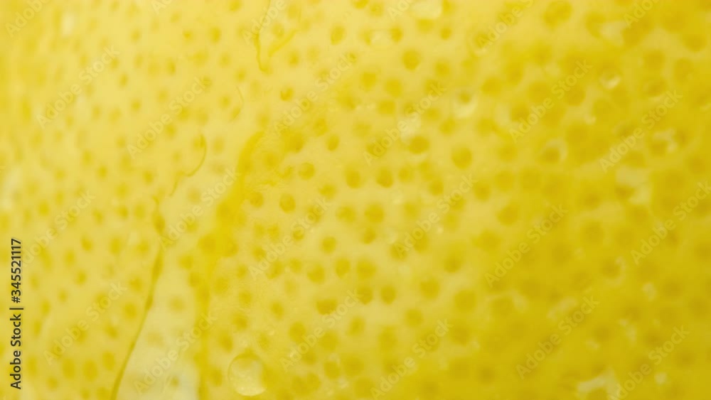Slow motion of droplet falling from fresh lemon peel. Close up. Fruit. Slow motion of droplet falling from fresh lemon peel. Close up. Fruit.