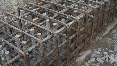 closeup foundation isnot completely poured with concrete. open frame made of steel reinforcement for laying foundation pit in residential building.