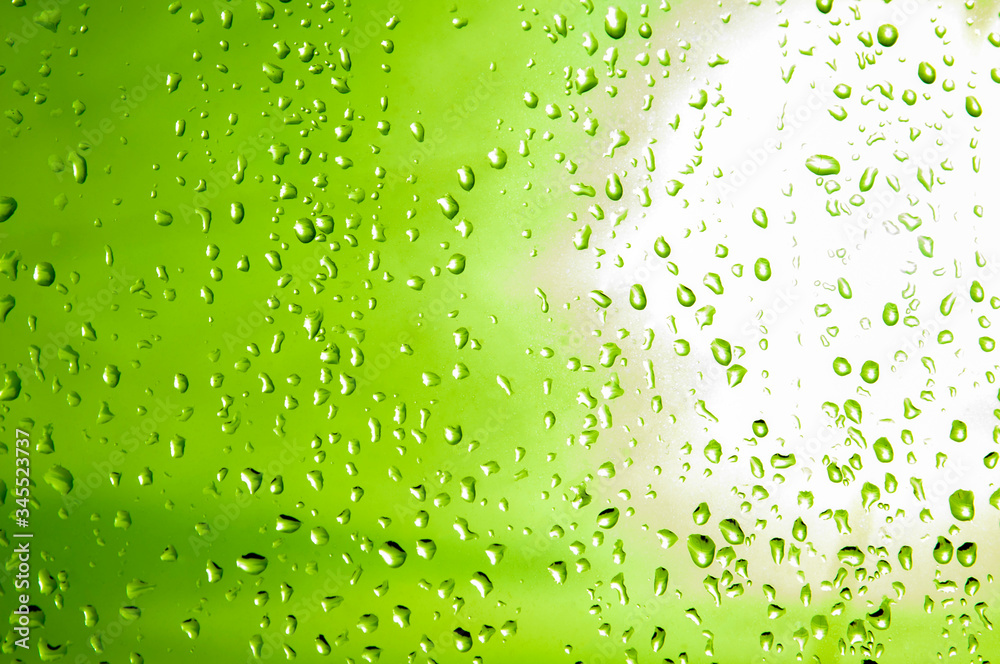 Blue water drops background. Drops of water on a green background. Drops of water on glass. 