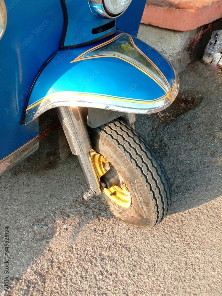 Front wheel of motor tricycle transport on the Thailand road. Stock