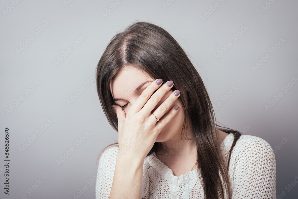 Close-up portrait of surprised attractive businesswoman covering her mouth by the hands, over white background Close-up portrait of surprised attractive businesswoman covering her mouth by the hands, over white background