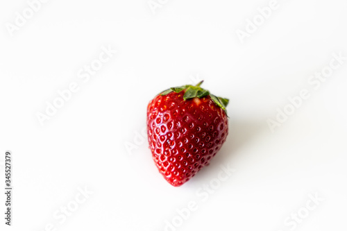 red juicy fresh ripe strawberry on a white herbed background