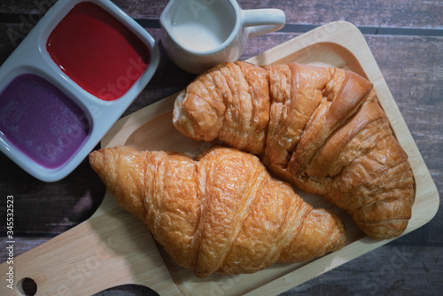 Tasty buttery croissants on  wooden table