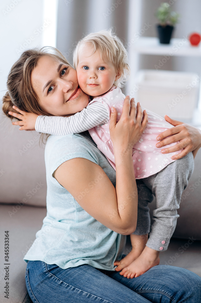 Mom and little daughter. Portrait of an amazing young mother and her adorable little beloved daughter, at home. Happy family Mom and little daughter. Portrait of an amazing young mother and her adorable little beloved daughter, at home. Happy family
