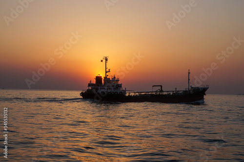 beautiful sunrise and ship on sea 