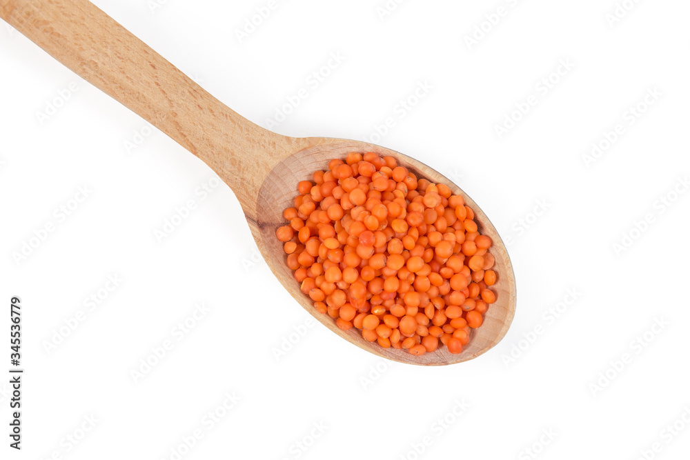 Uncooked red lentil in wooden spoon, top view close-up Uncooked red lentil in wooden spoon, top view close-up