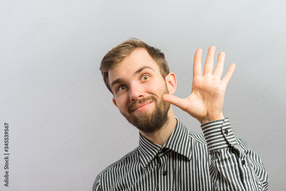 young man waving, smiling