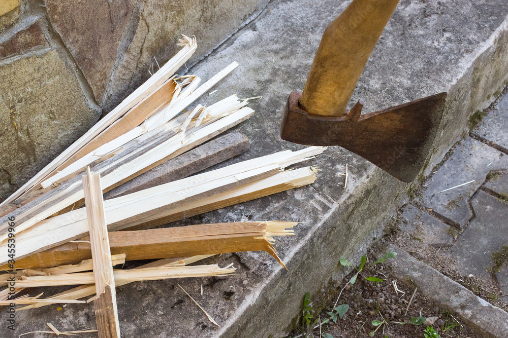 cutting wood. Close-up of axe and chopped firewood at the background. Lumberjack village life away from the city and diseases cutting wood. Close-up of axe and chopped firewood at the background. Lumberjack village life away from the city and diseases