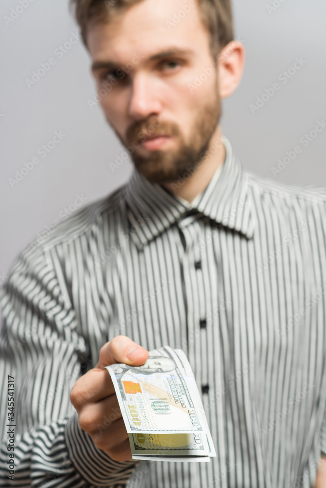 Handsome young casual man isolated - holding a 100 dollars bills Handsome young casual man isolated - holding a 100 dollars bills
