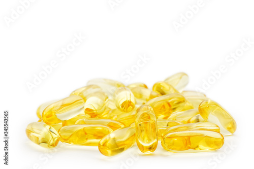 Closeup of capsules fish oil with Omega 3 on white background. Shallow focus.