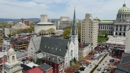Capitol building with beautiful dome, government buildings, church steeple, aerial drone footage, protesters line steps