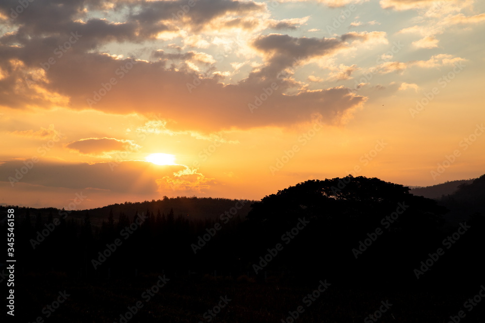 silhouette landscape mountain and sun light beam on twilight sky in the morning . silhouette landscape mountain and sun light beam on twilight sky in the morning .