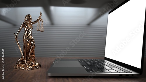 Internetrecht - Justitia Statue vor einem Notebook photo