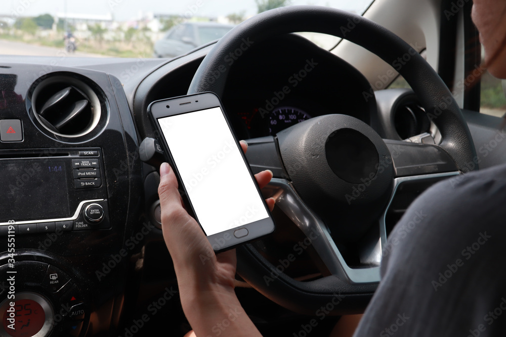 Woman driving car playing phone