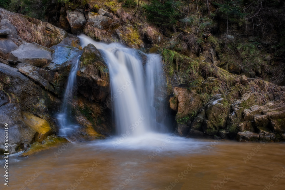 Kamyanka waterfall in Ukrainian Carpathian mountains. Long exposure shot, april 2020 Kamyanka waterfall in Ukrainian Carpathian mountains. Long exposure shot, april 2020