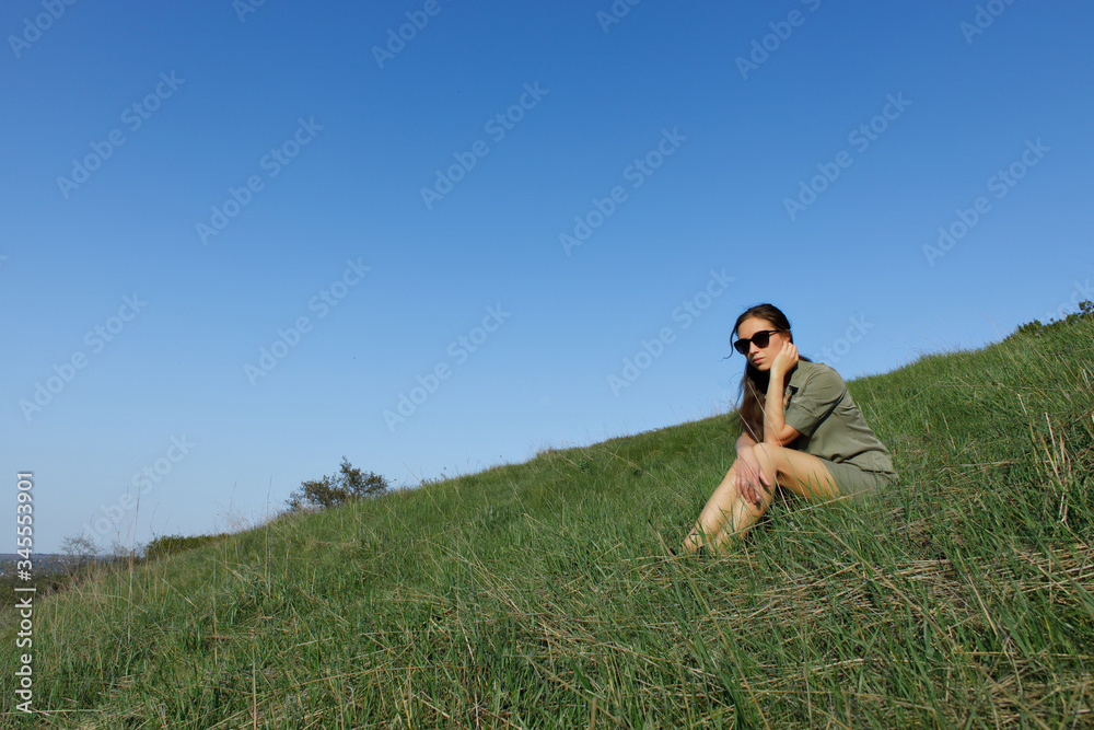 young beautiful girl runs on the green hills of the mountains young beautiful girl runs on the green hills of the mountains