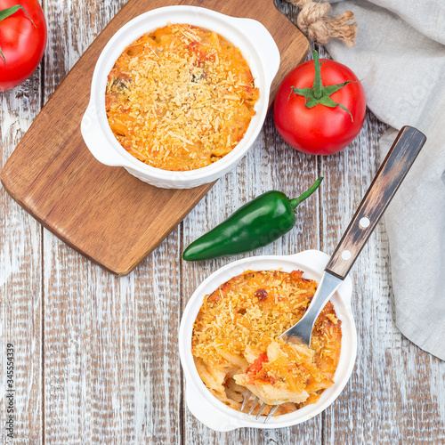 Mac and cheese with mini penne pasta, in baking dish, top view, square format photo