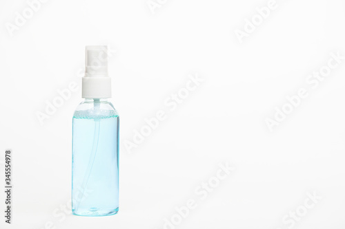 Unbranded container with dispenser for disinfector products. Transparent plastic bottle with sanitizer for hands. Copy space. Health and hygiene concept. Isolated on white