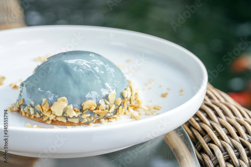 Earl Grey Mousse Cake in white plate, nature background.