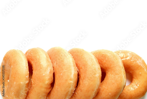 Row of Mouthwatering Sugar-glazed Donuts Isolated on White Background photo