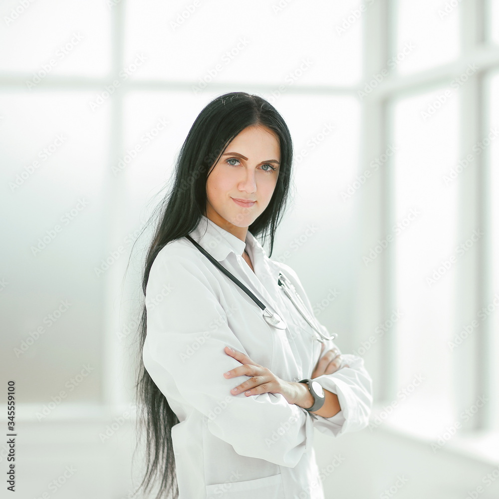 female therapist standing by the hospital window female therapist standing by the hospital window