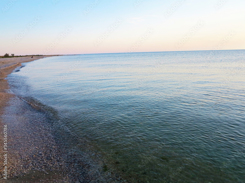 coast of the sea against the background of the sunset 
