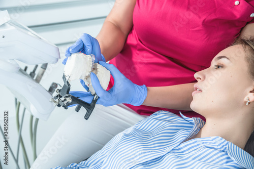 Female dentist doctor holds dental mouthguard in hands, splint therapy in dentistry to correct bite. The concept of health care and treatment in medical facilities