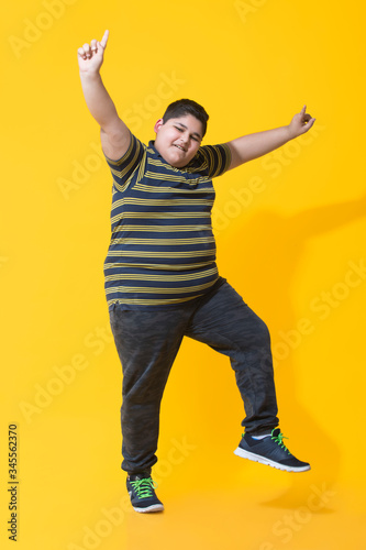 Chubby boy smiling and dancing.(Obesity) 