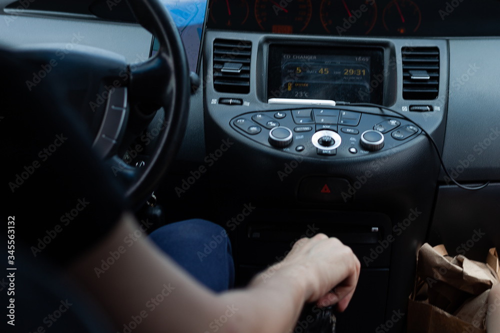 Man driving. The driver holds the steering wheel with his hand.