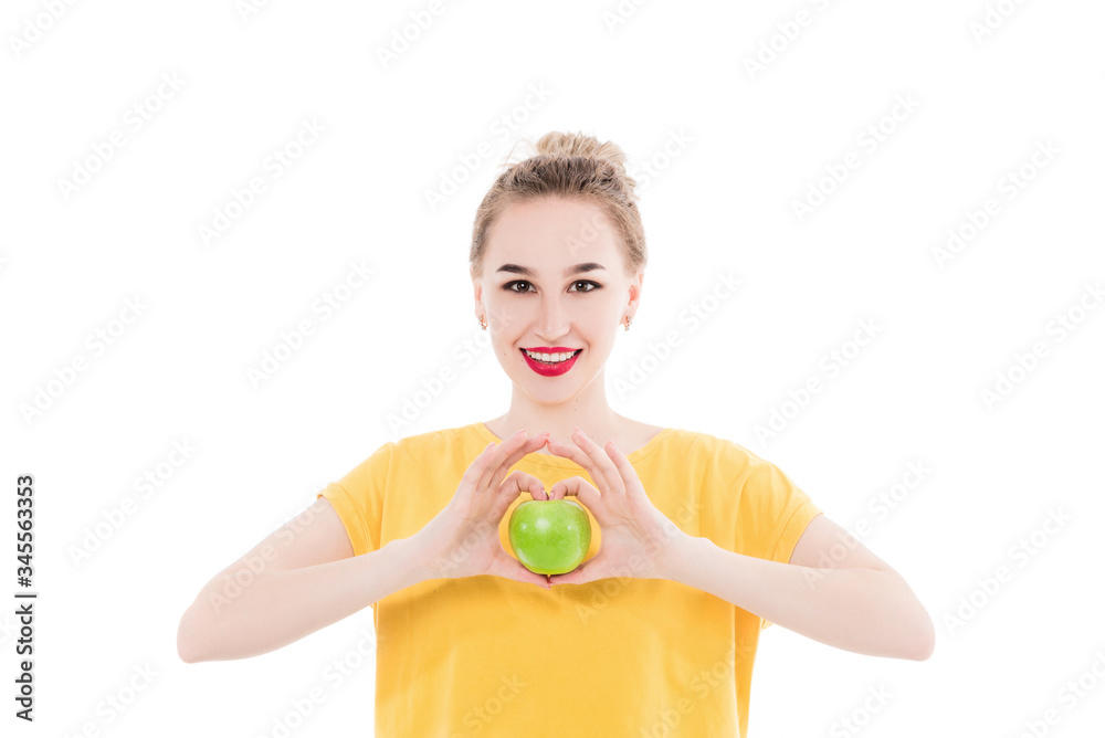 Emotional portrait of a girls who eat an apple on an isolated white background. The concept of a healthy diet, healthy lifestyle and vegetarianism