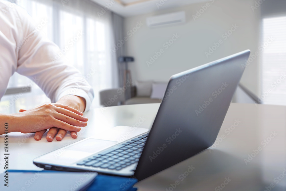 Businessman sitting with a laptop working from home Businessman sitting with a laptop working from home
