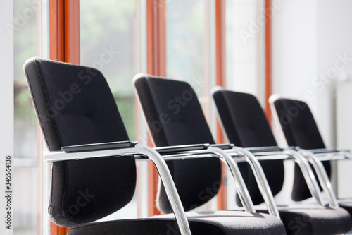 Chairs in a row in a sunny waiting room or lounge