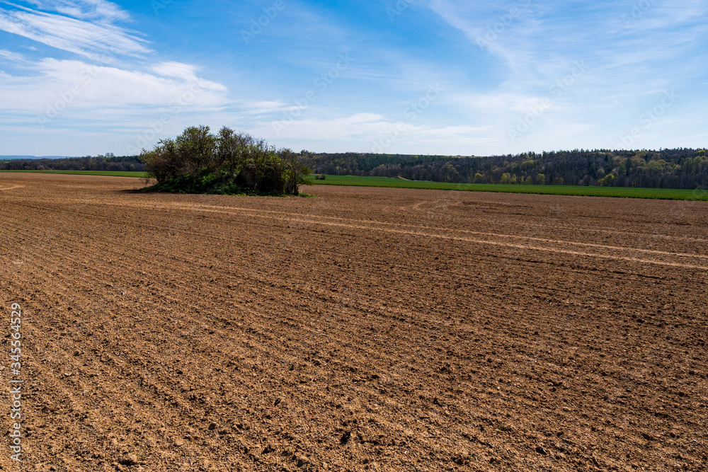 Agricultural field,brown soil farm landscape.Line of arable land. Agricultural field,brown soil farm landscape.Line of arable land.