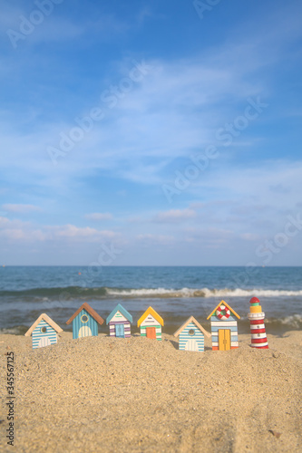 Miniature huts and lighthouse at beach
