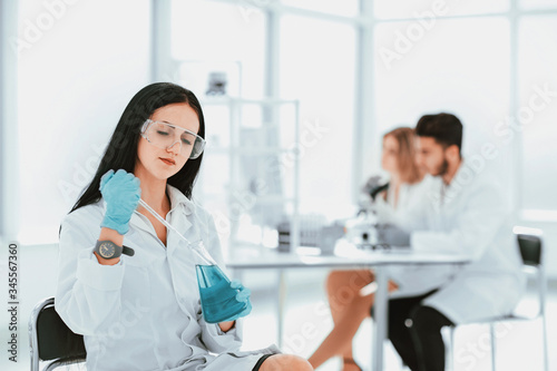 close up.woman scientist takes a sample of the liquid .