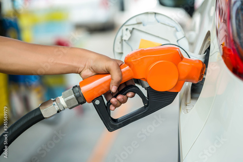 Man Refill and filling Oil Gas Fuel at station.Gas station - refueling.To fill the machine with fuel. Car fill with gasoline at a gas station. Gas station pump. 